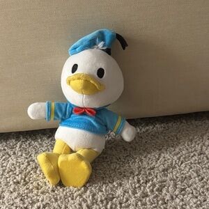 Plush Toy with Blue Outfit and Yellow Feet